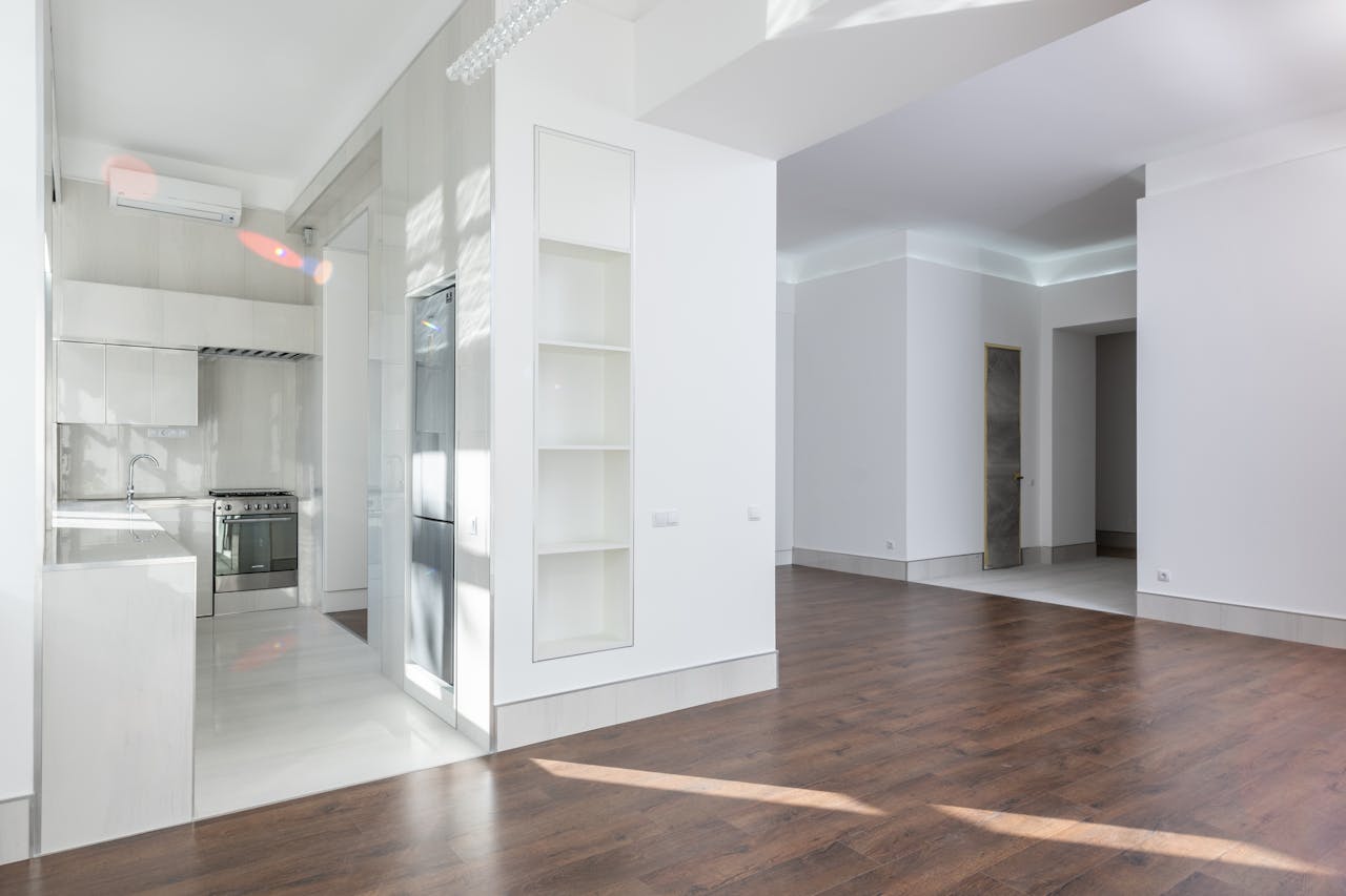about-01 Spacious modern interior featuring an open kitchen and living area with elegant wooden flooring, ideal for contemporary homes.